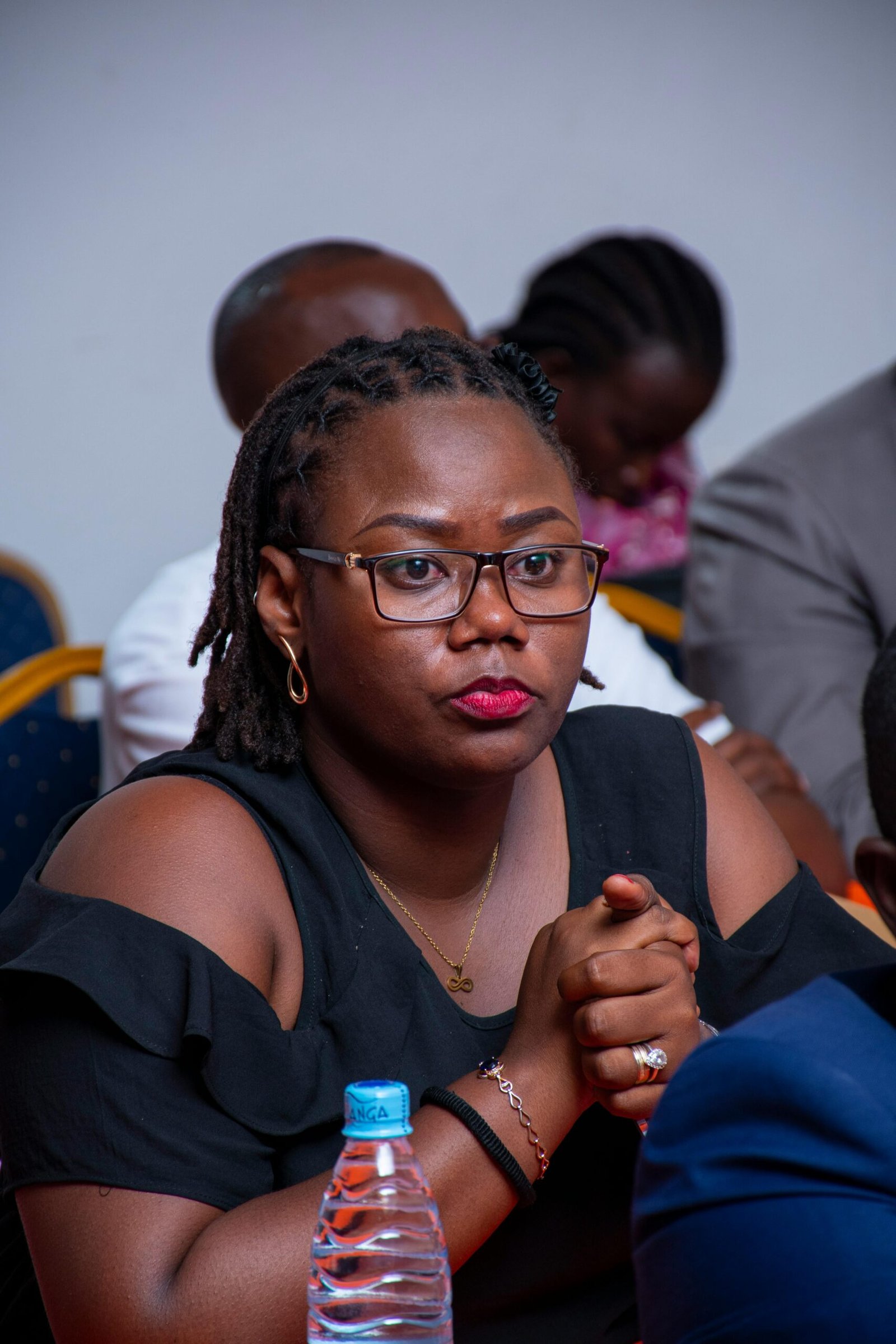 Engaged woman in a conference room attentively listening during a lecture in Bujumbura.